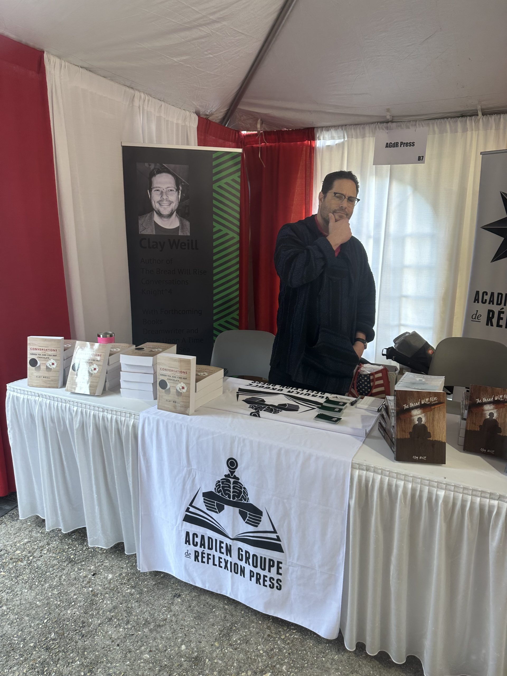 Clay C. Weill behind an AGdR Press table displaying his books at the 2025 Louisiana Book Festival.
